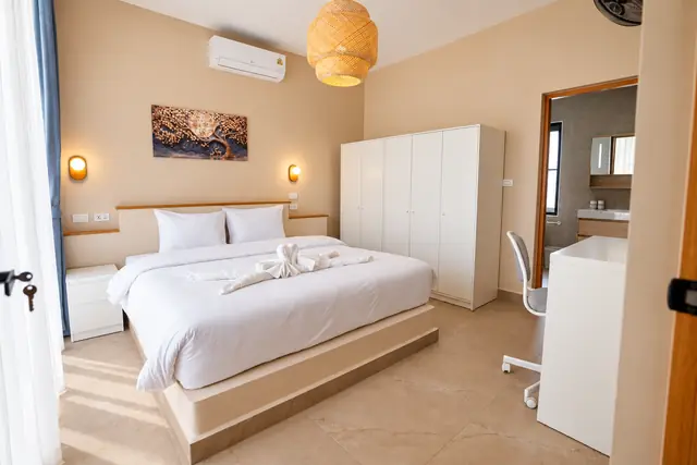 Cozy bedroom with swan decor on bed