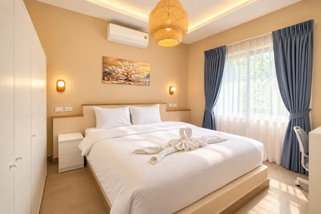 Bedroom with wardrobe and blue curtains
