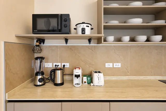 Modern beige kitchen with appliances and dishes