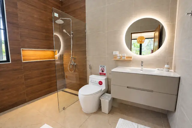 Modern beige bathroom with shower and toilet
